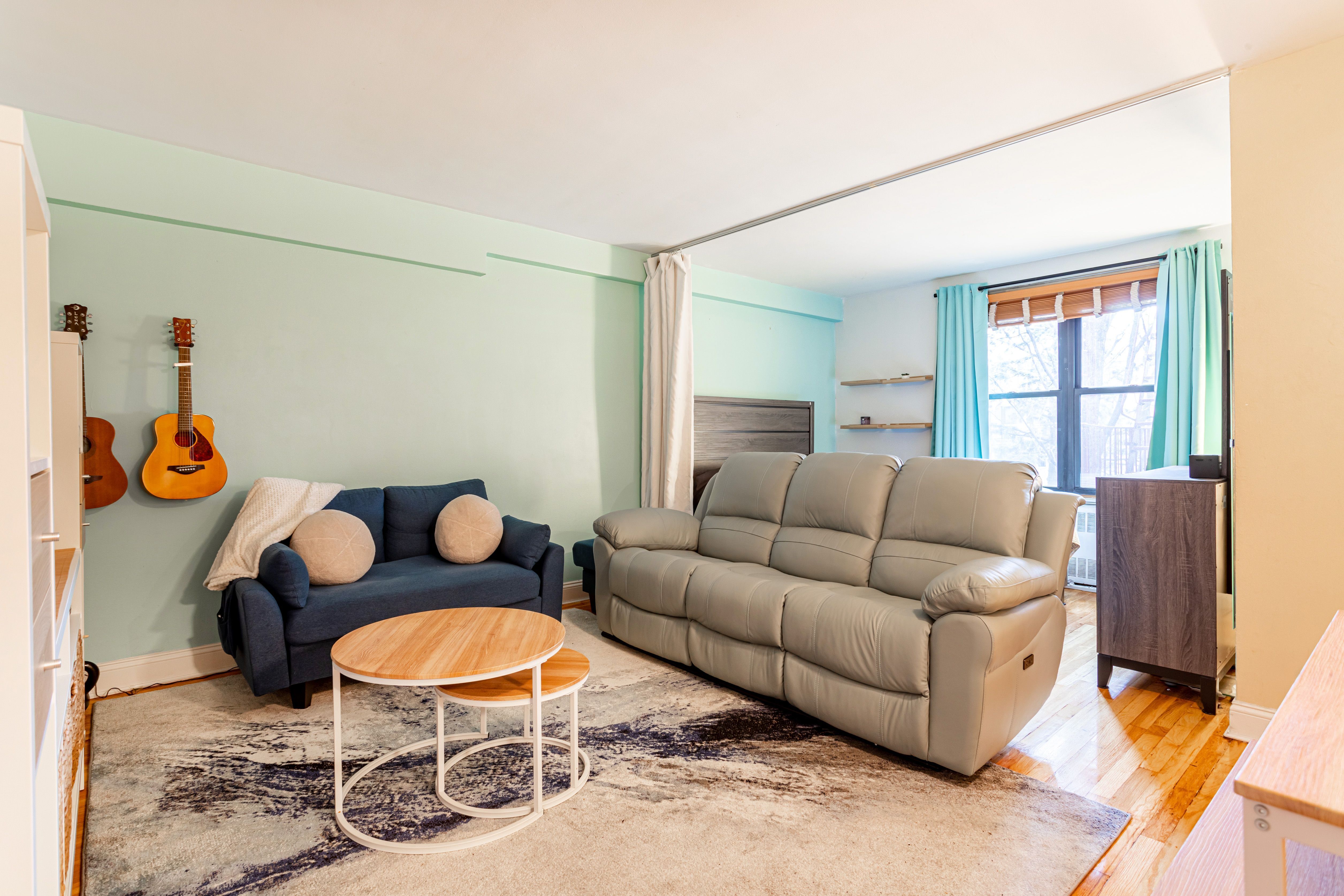 65-15 38th Avenue, Unit 2A Queens, NY 11377 - Photo 2 of 16 a living room with furniture a rug and a window