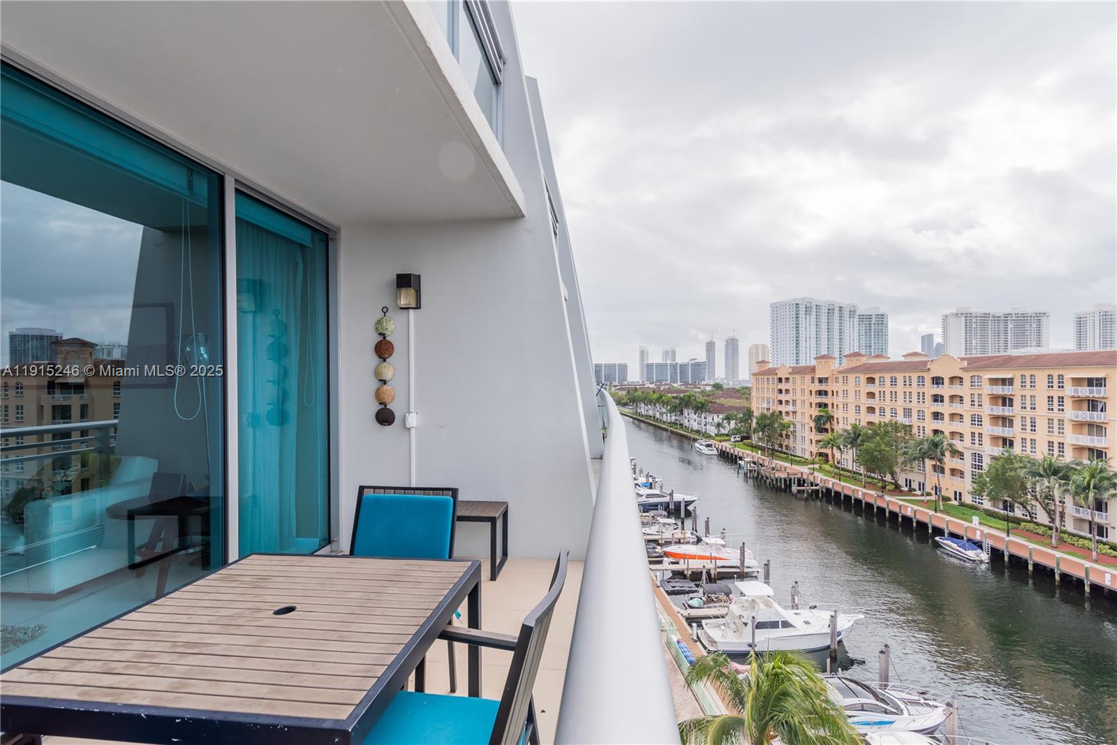 2950 Northeast 188th Street, Unit 504 Aventura, FL 33180 - Photo 1 of 33 a balcony with table and chairs