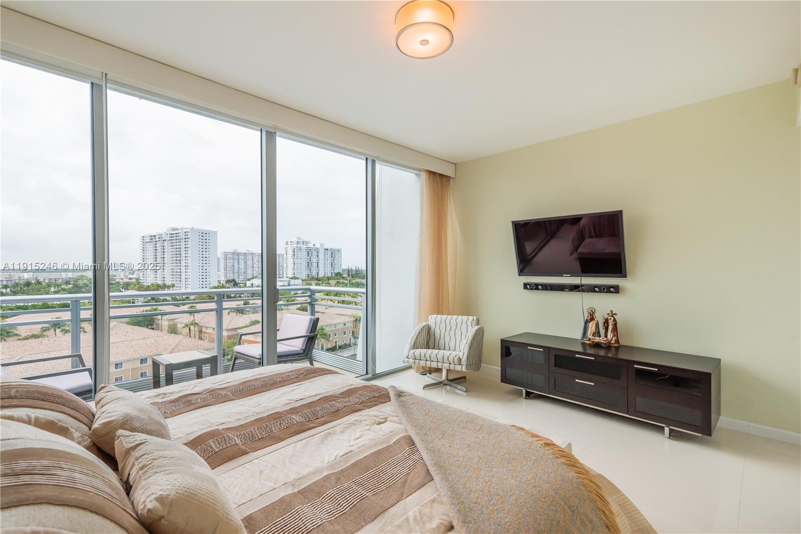 2950 Northeast 188th Street, Unit 504 Aventura, FL 33180 - Photo 16 of 33 a bedroom with a bed and a flat screen tv