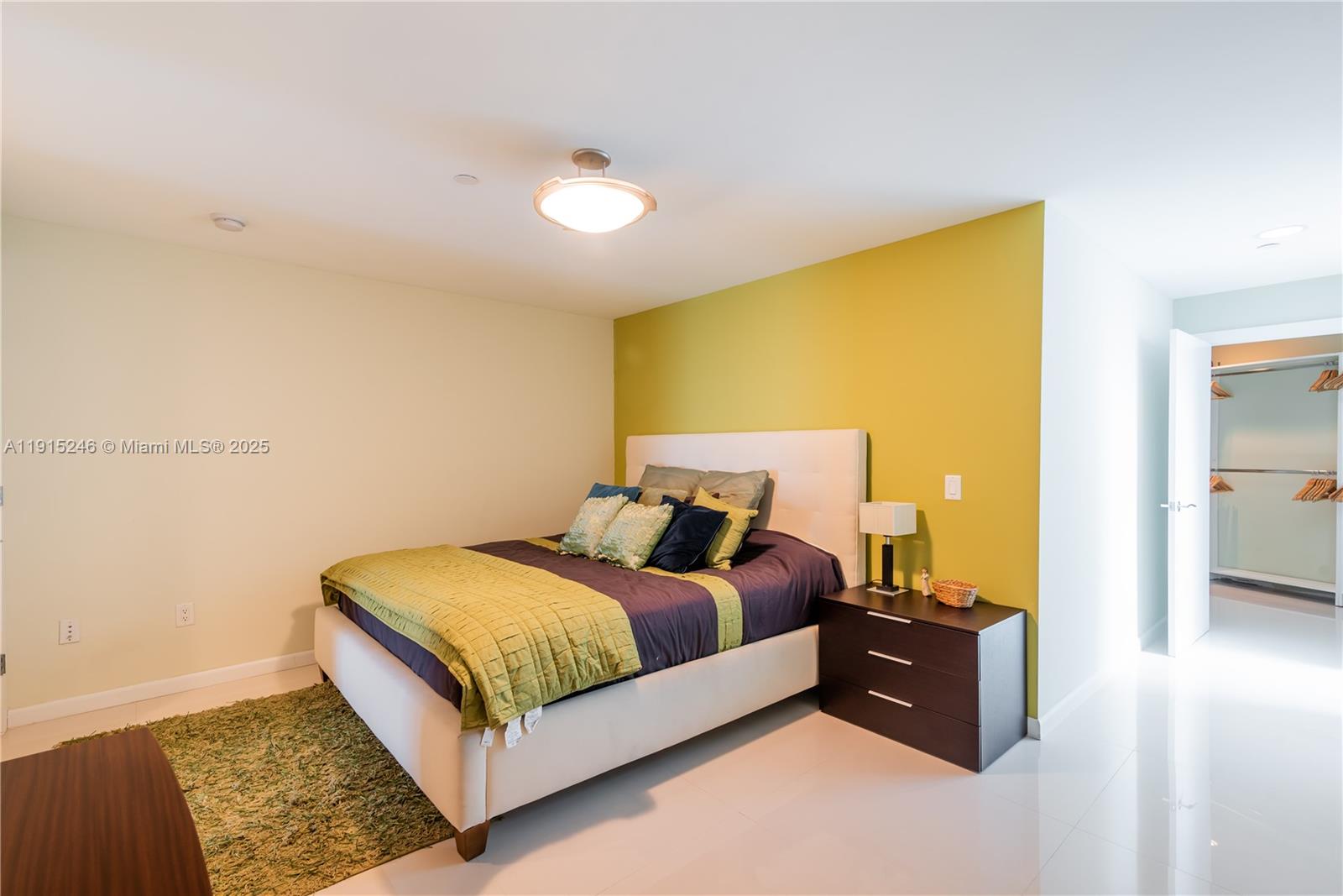 2950 Northeast 188th Street, Unit 504 Aventura, FL 33180 - Photo 18 of 33 a bedroom with a bed and wooden floor