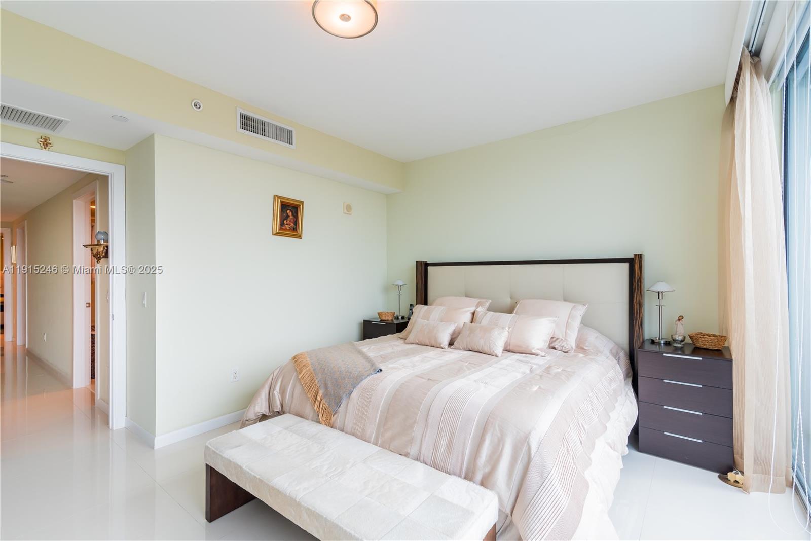 2950 Northeast 188th Street, Unit 504 Aventura, FL 33180 - Photo 21 of 33 a bedroom with a bed and a night stand