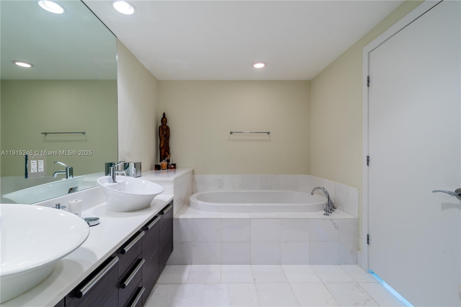 2950 Northeast 188th Street, Unit 504 Aventura, FL 33180 - Photo 22 of 33 a bathroom with a tub sink and mirror