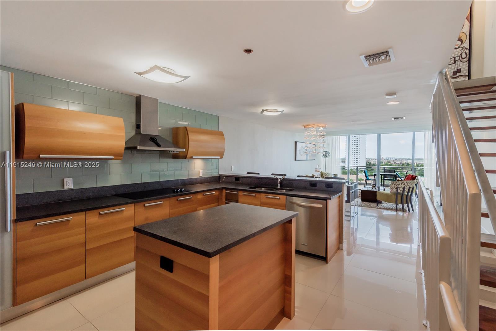 2950 Northeast 188th Street, Unit 504 Aventura, FL 33180 - Photo 4 of 33 a kitchen with stainless steel appliances a sink a counter top space cabinets and a window