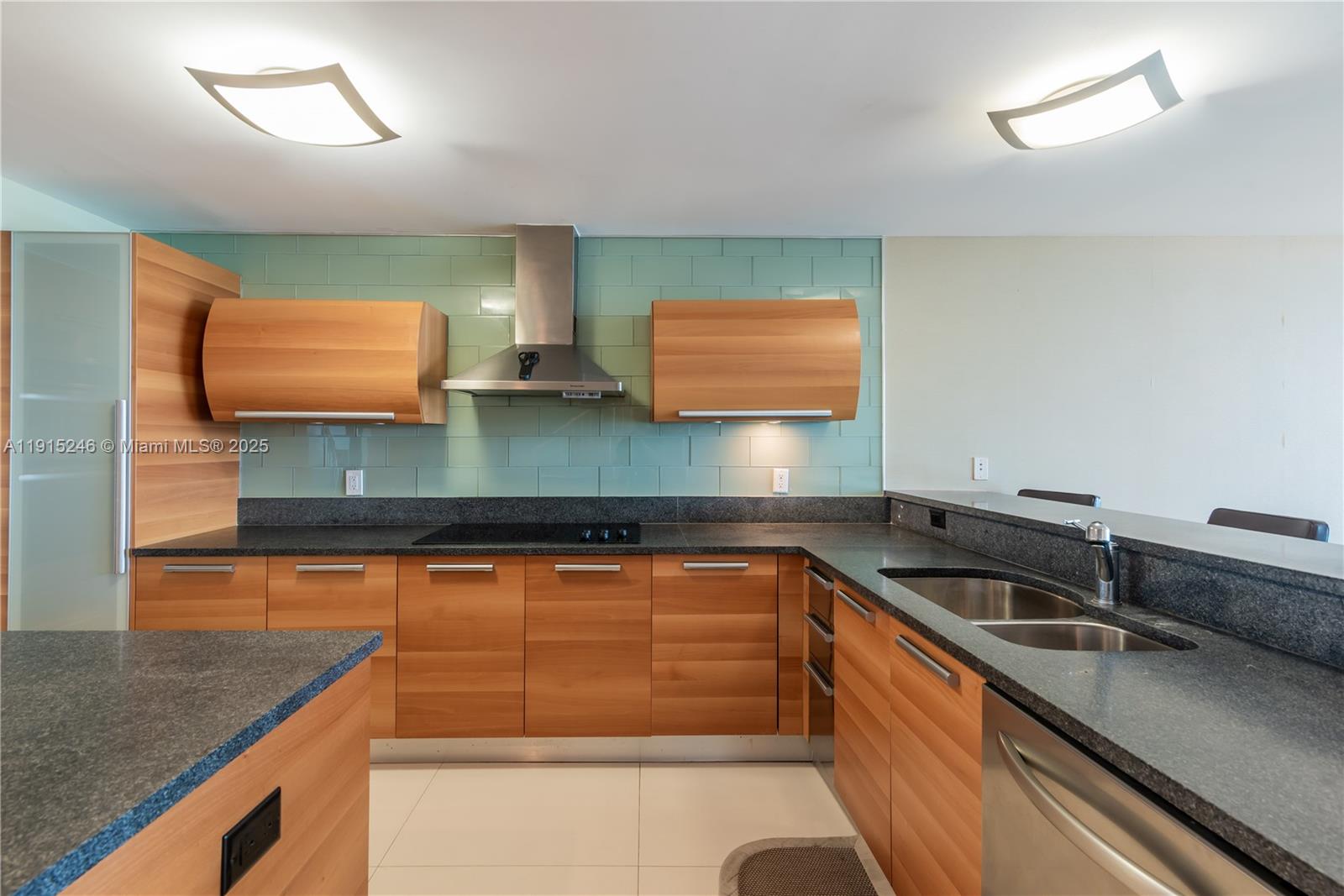 2950 Northeast 188th Street, Unit 504 Aventura, FL 33180 - Photo 6 of 33 a kitchen with stainless steel appliances granite countertop a sink and a stove