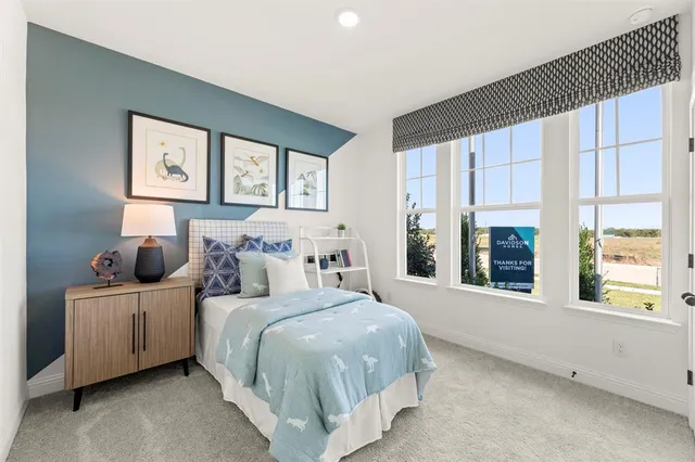 a bedroom with bed and large windows