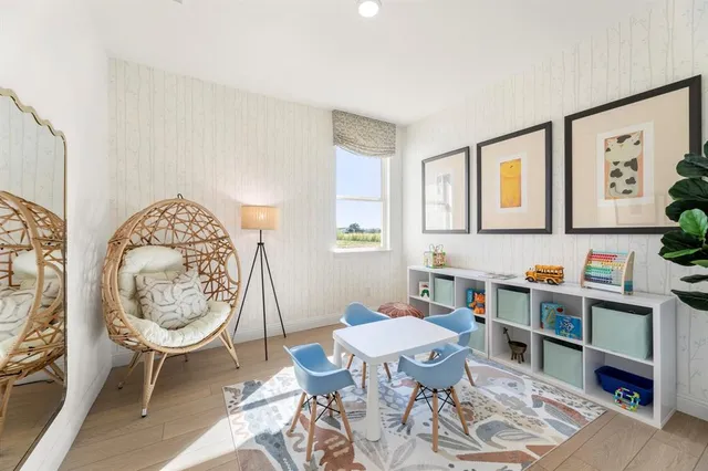 a living room with furniture a rug and a large window
