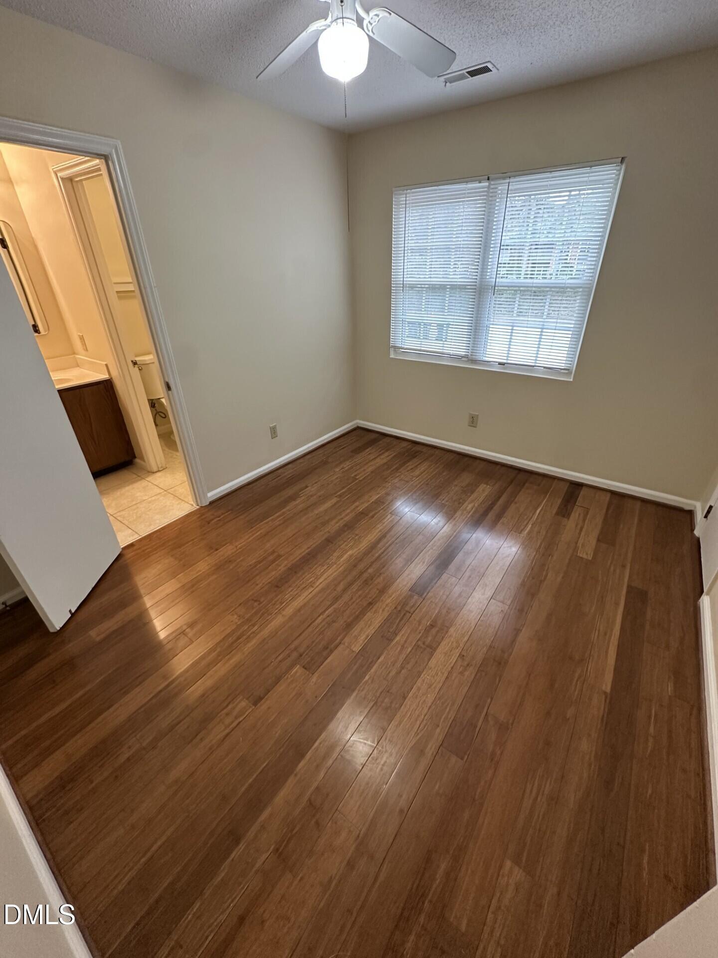 4912 North New Hope Road Raleigh, NC 27616 - Photo 11 of 14 a view of an empty room with wooden floor and a window