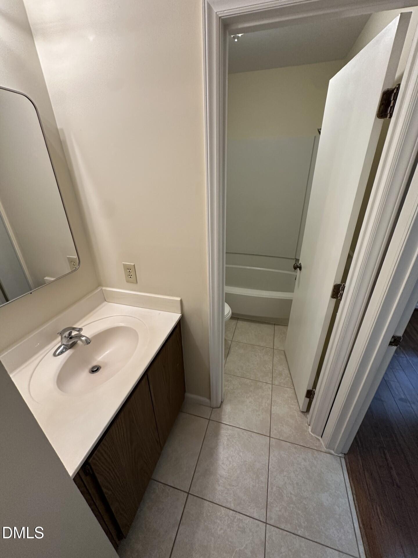 4912 North New Hope Road Raleigh, NC 27616 - Photo 13 of 14 a bathroom with a sink vanity and tub