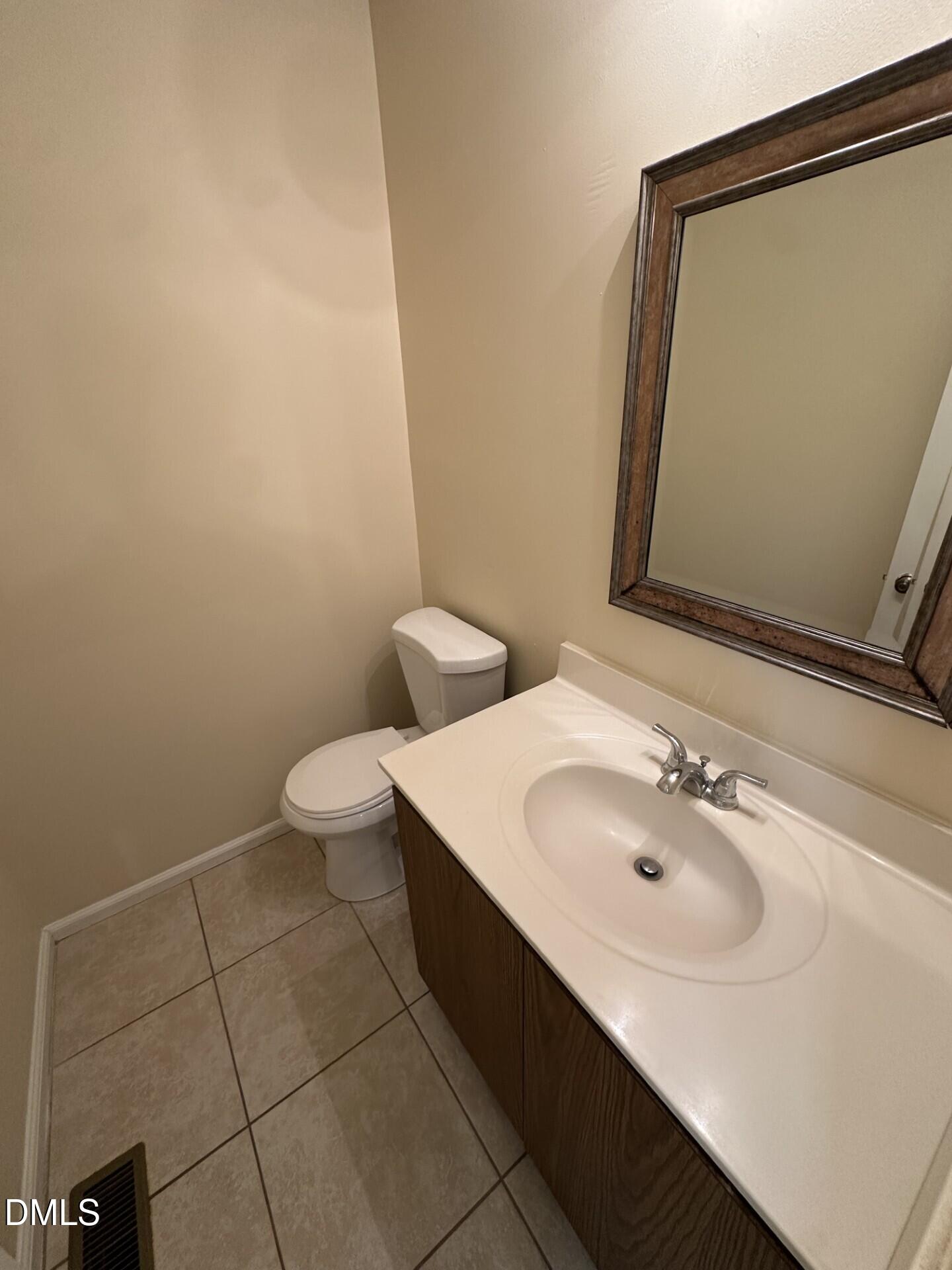4912 North New Hope Road Raleigh, NC 27616 - Photo 8 of 14 a bathroom with a sink a toilet and mirror