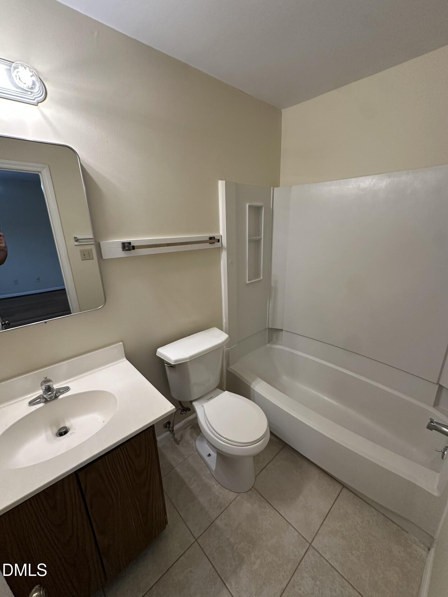 4912 North New Hope Road Raleigh, NC 27616 - Photo 10 of 14 a bathroom with a sink a toilet and bathtub