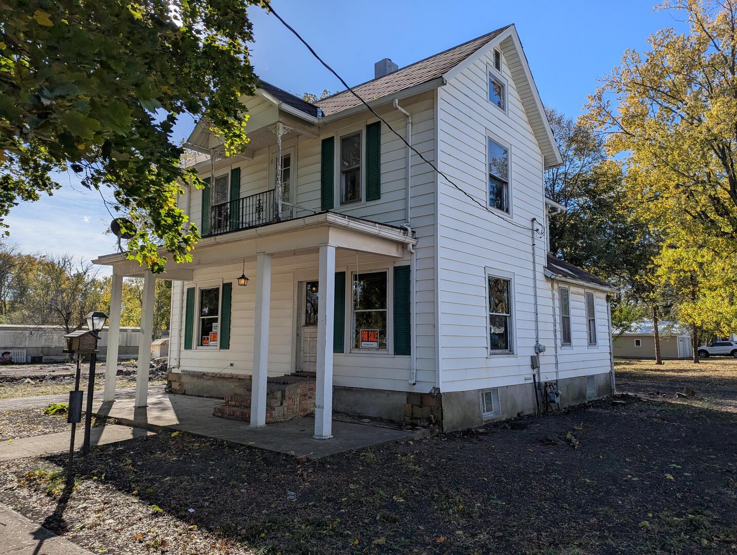 a view of a white house with a yard