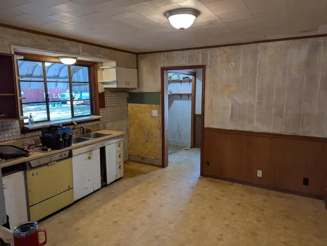 a living room with wooden floor and large window