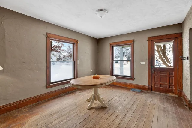 a view of an empty room with a fireplace and a window
