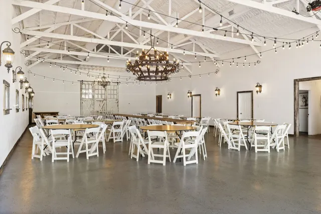 an aerial view of residential houses with outdoor space and seating