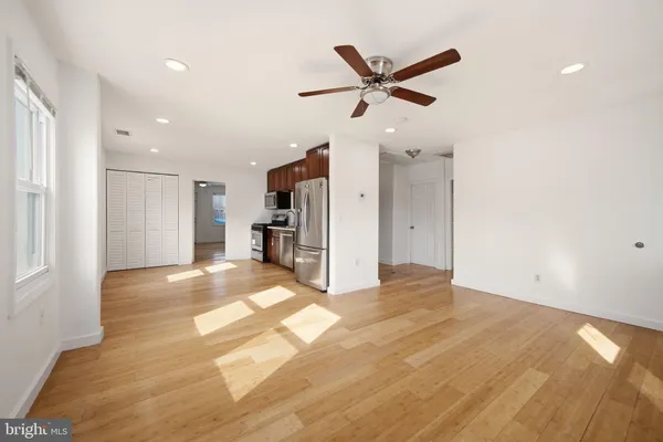 a view of a livingroom with a ceiling fan and window