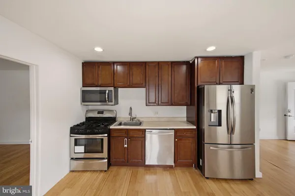 a kitchen with stainless steel appliances a refrigerator stove and sink