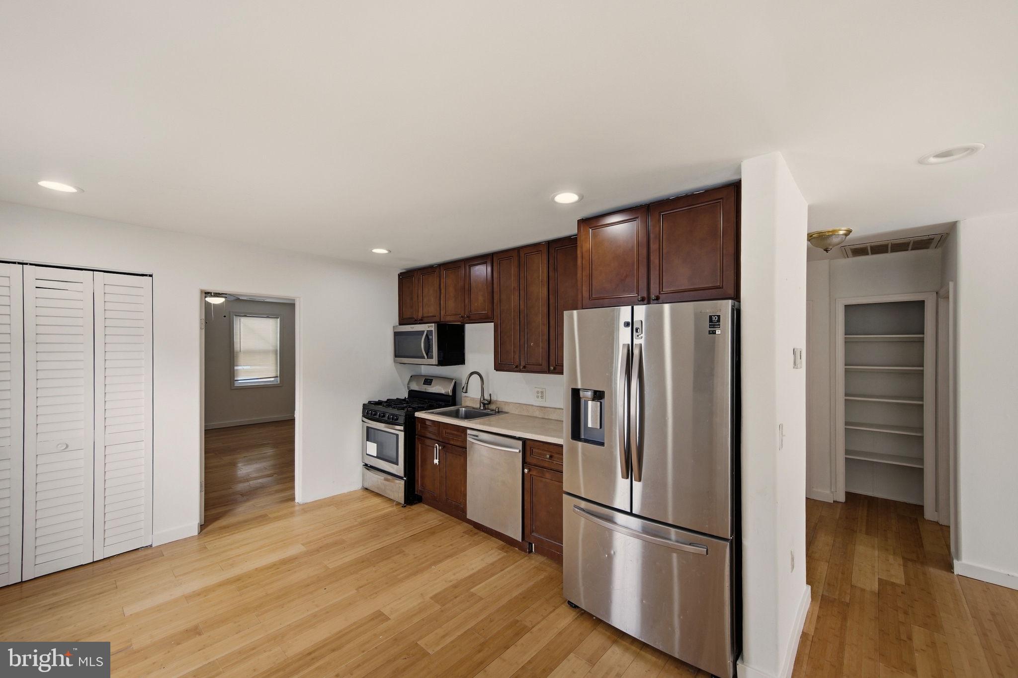 1812 Kitty Hawk Road Essex, MD 21221 - Photo 13 of 44 a kitchen with granite countertop stainless steel appliances a refrigerator and cabinets