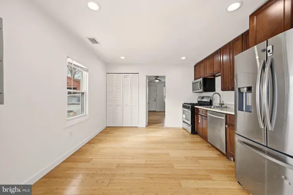a kitchen with stainless steel appliances a refrigerator and a stove top oven