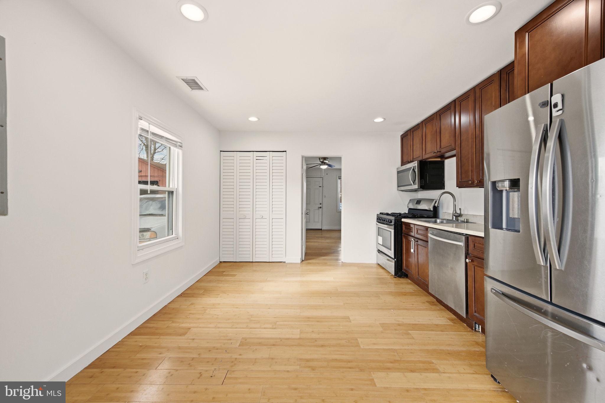1812 Kitty Hawk Road Essex, MD 21221 - Photo 14 of 44 a kitchen with stainless steel appliances a refrigerator and a stove top oven