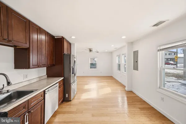 a kitchen with stainless steel appliances granite countertop a refrigerator and a stove top oven