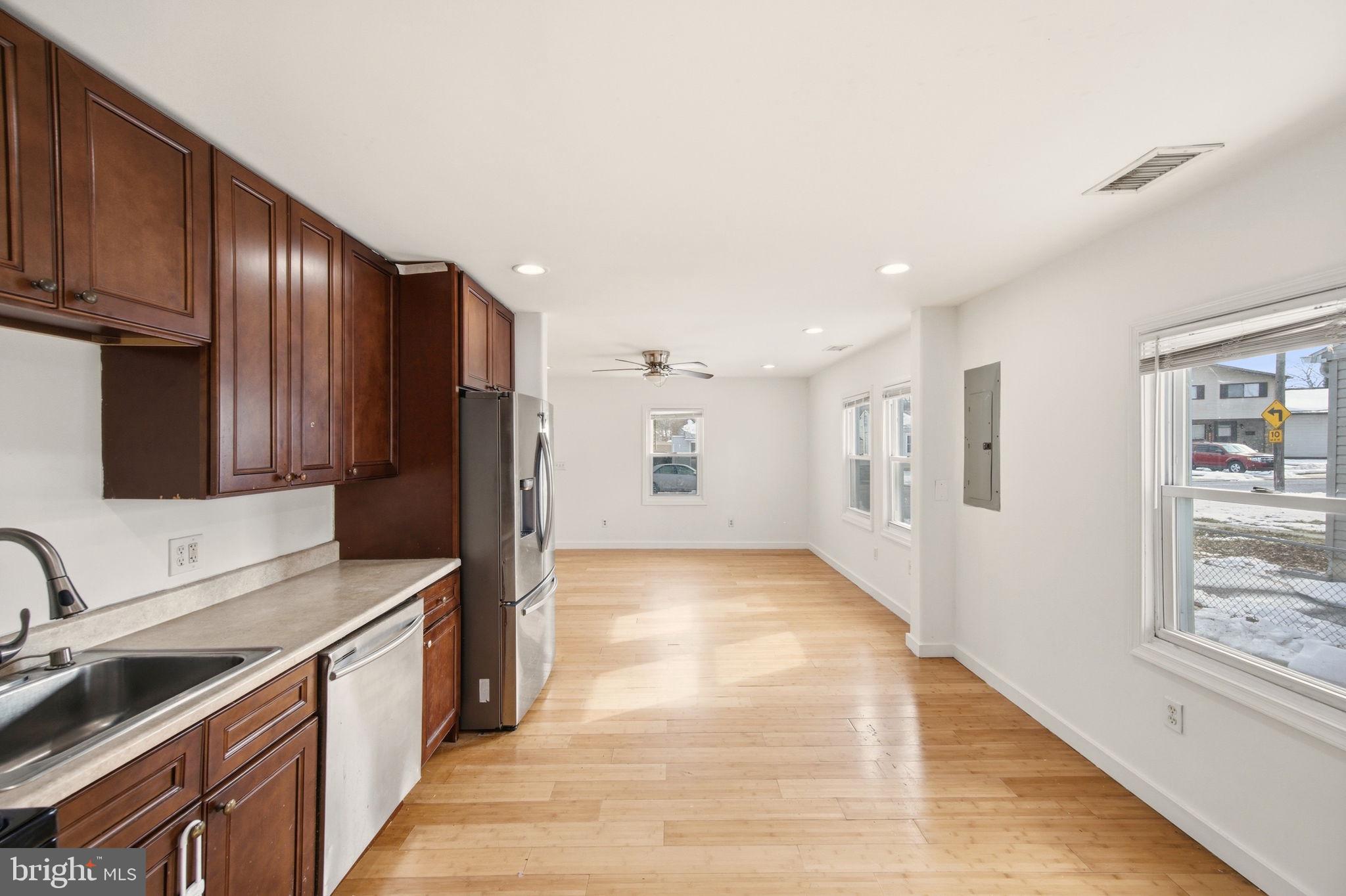 1812 Kitty Hawk Road Essex, MD 21221 - Photo 15 of 44 a kitchen with stainless steel appliances granite countertop a refrigerator and a stove top oven