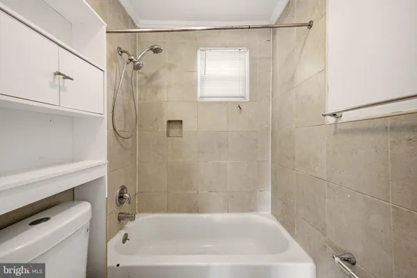a bath tub sitting next to a white sink and vanity