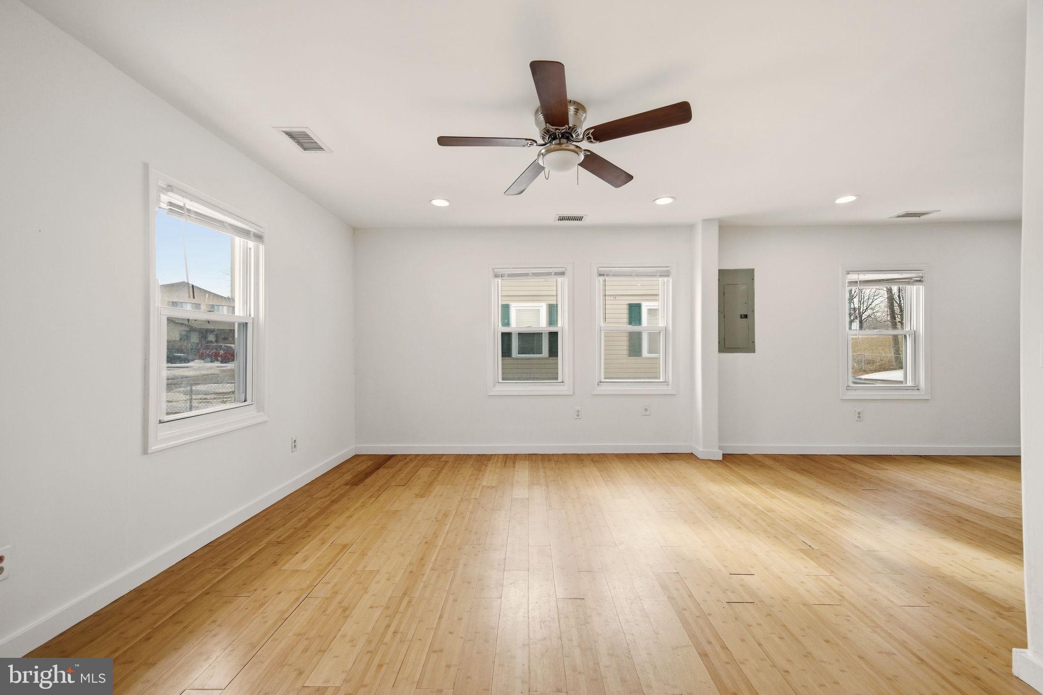 1812 Kitty Hawk Road Essex, MD 21221 - Photo 8 of 44 a view of empty room with wooden floor and fan