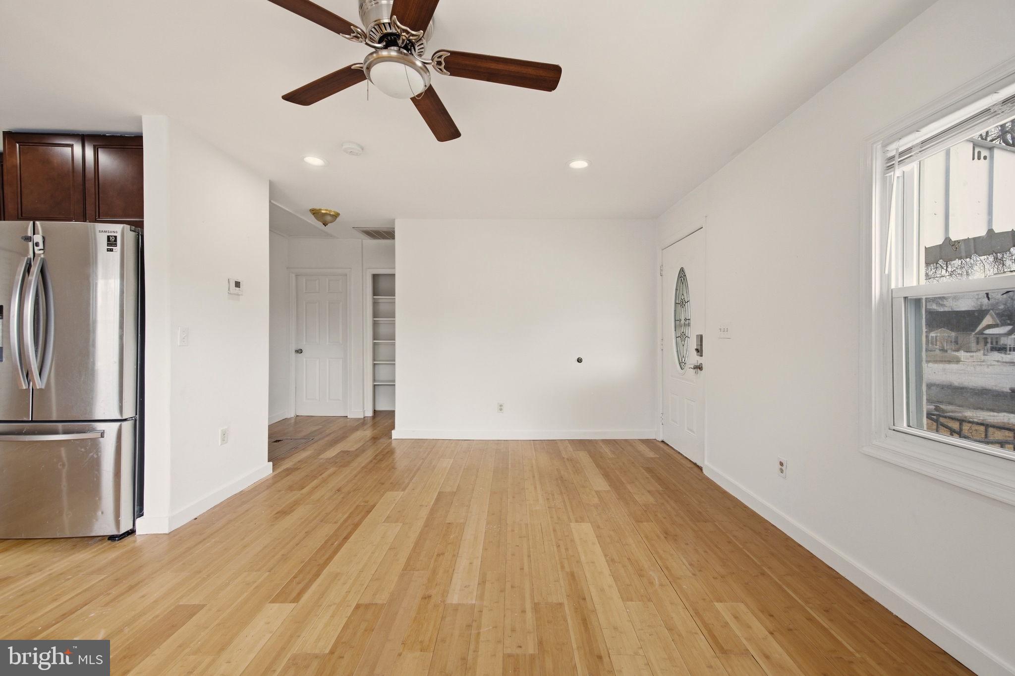 1812 Kitty Hawk Road Essex, MD 21221 - Photo 10 of 44 a view of empty room with wooden floor and fan