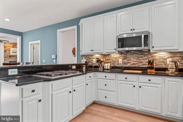 a view of a dining room with furniture a chandelier and window