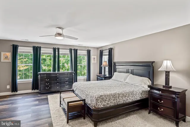a bedroom with a bed and ceiling fan