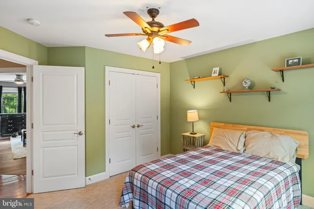 a bedroom with a bed and a large window