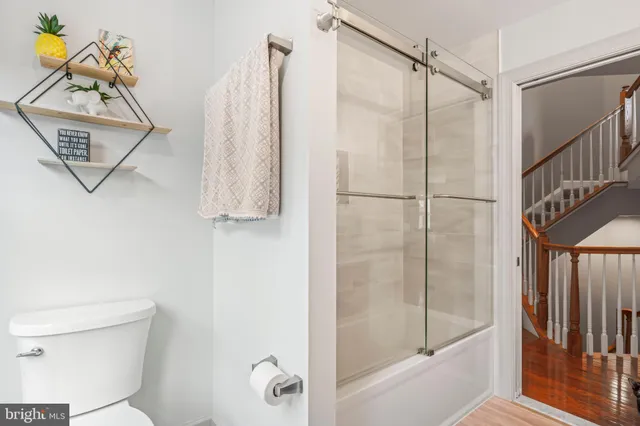 a view of entryway with a front door and wooden floor