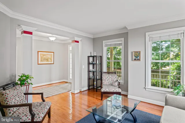a living room with furniture a large window with wooden floor