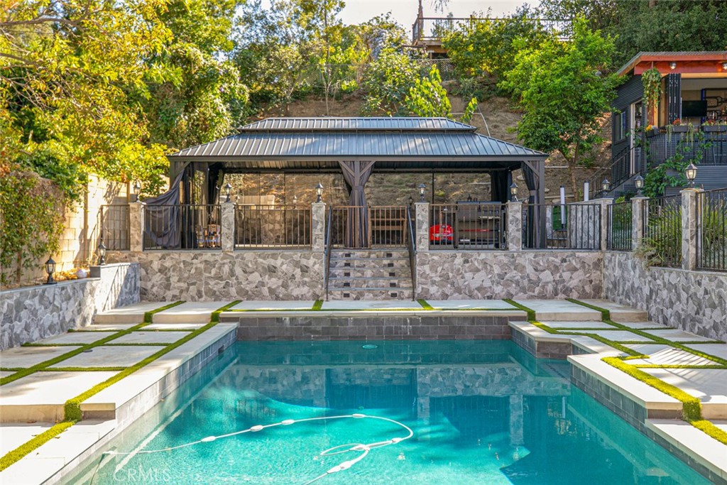 18810 Kirkcolm Lane Porter Ranch, CA 91326 - Photo 39 of 75 swimming pool view with a seating space and garden view