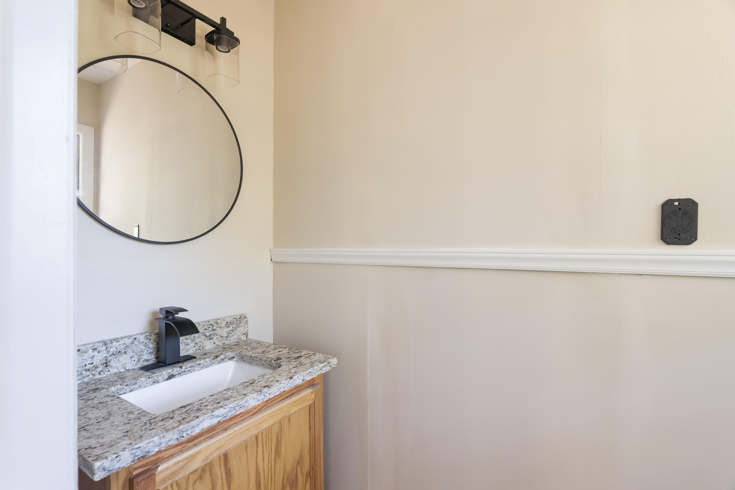 39 Gantt Street Wagener, SC 29164 - Photo 16 of 30 a bathroom with a granite countertop sink and a mirror