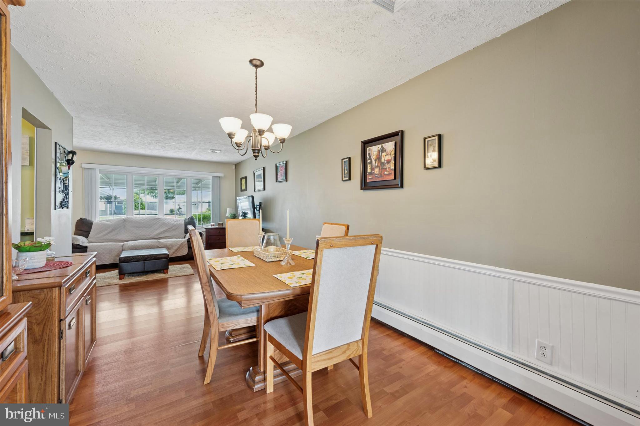 15 Paul Road Maple Shade, NJ 08052 - Photo 8 of 26 a dining room with wooden floor a chandelier a wooden table and chairs