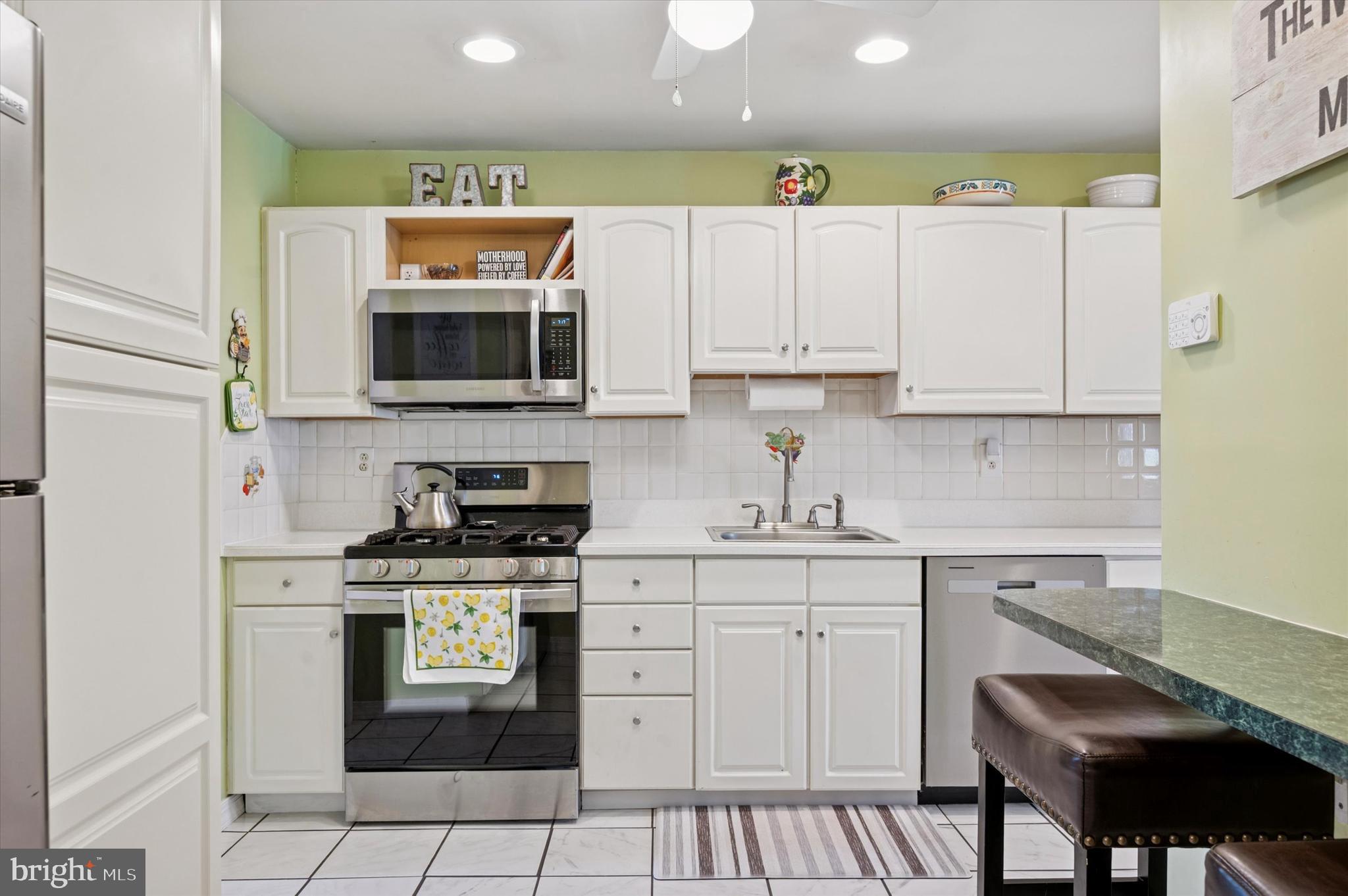 15 Paul Road Maple Shade, NJ 08052 - Photo 10 of 26 a kitchen with stainless steel appliances granite countertop a stove a sink and a microwave