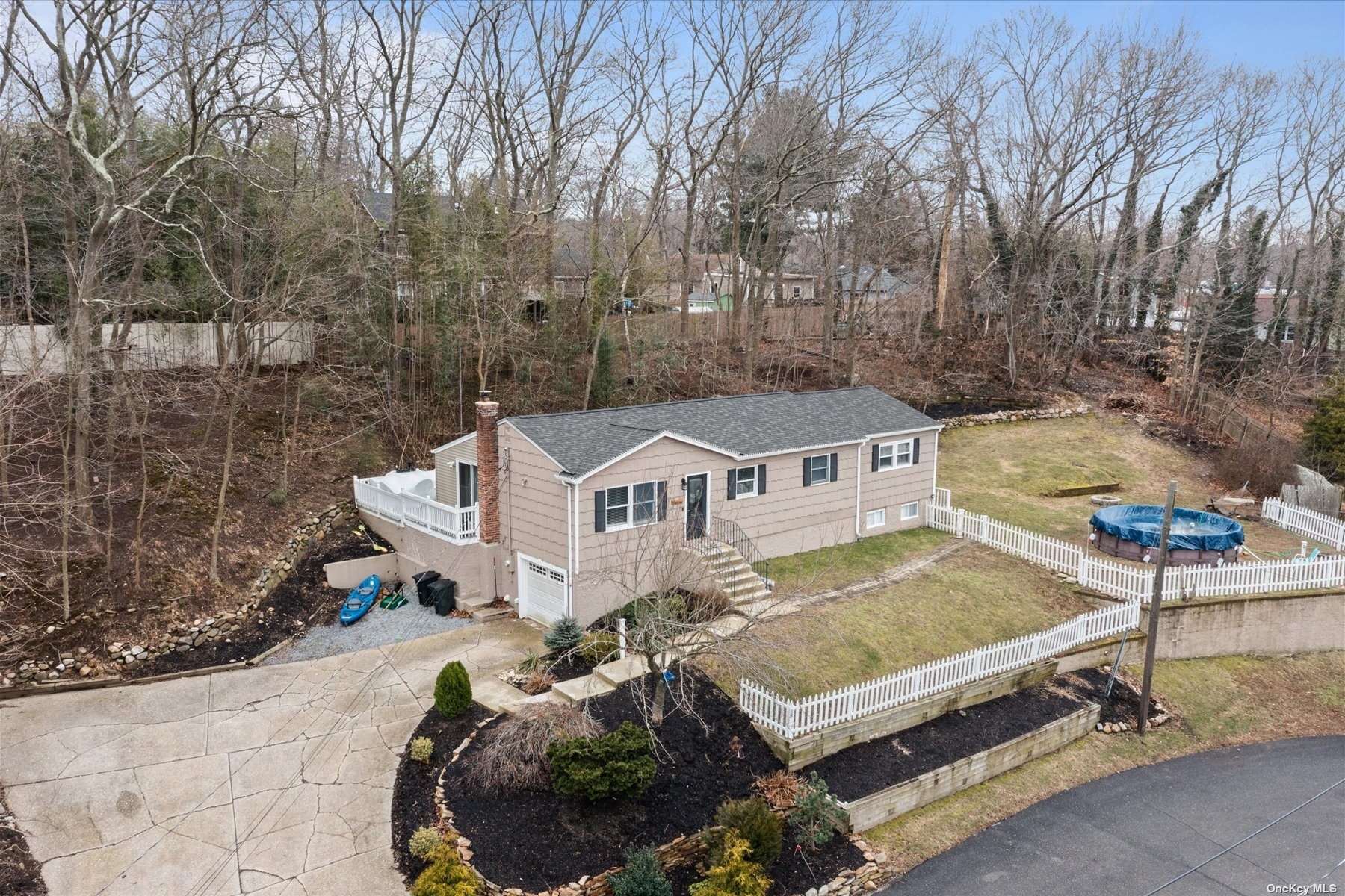 38 Belmont Road Sound Beach, NY 11789 - Photo 1 of 1 a front view of a house with a garden and patio