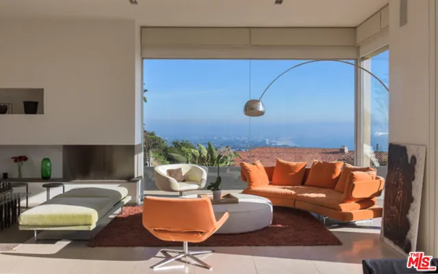 a living room with furniture and a lamp