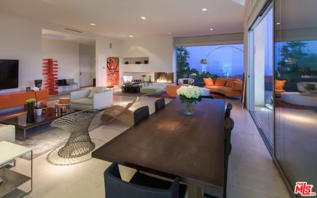 a view of a patio with couches chairs and a potted plants
