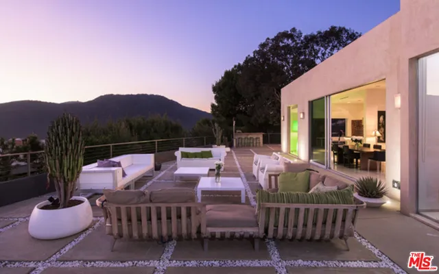 a view of a patio with couches and potted plants