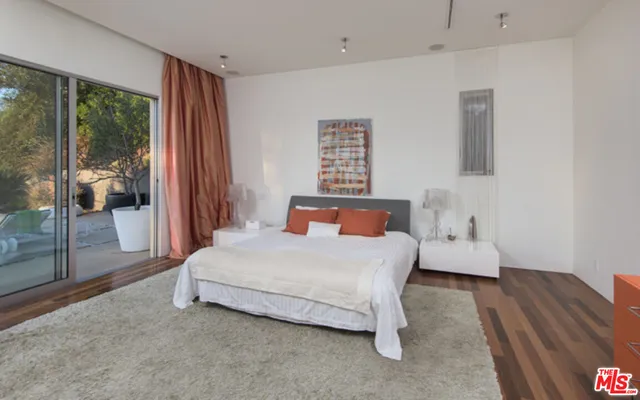 a en suite bathroom with a double vanity sink a large mirror and a shower