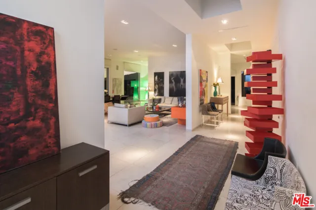 a living room with furniture and flowers