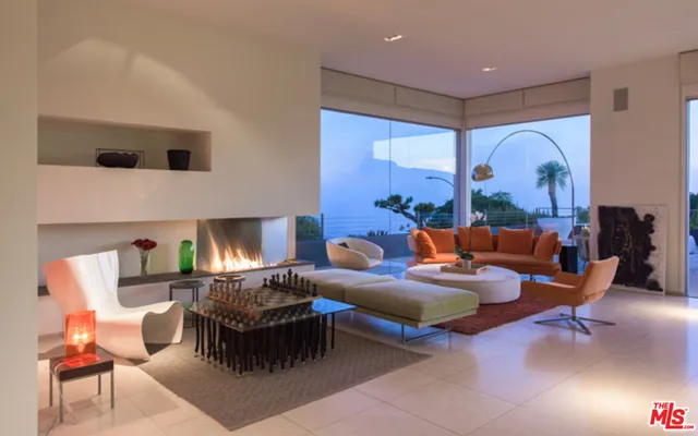 a living room with furniture a lamp and a fireplace