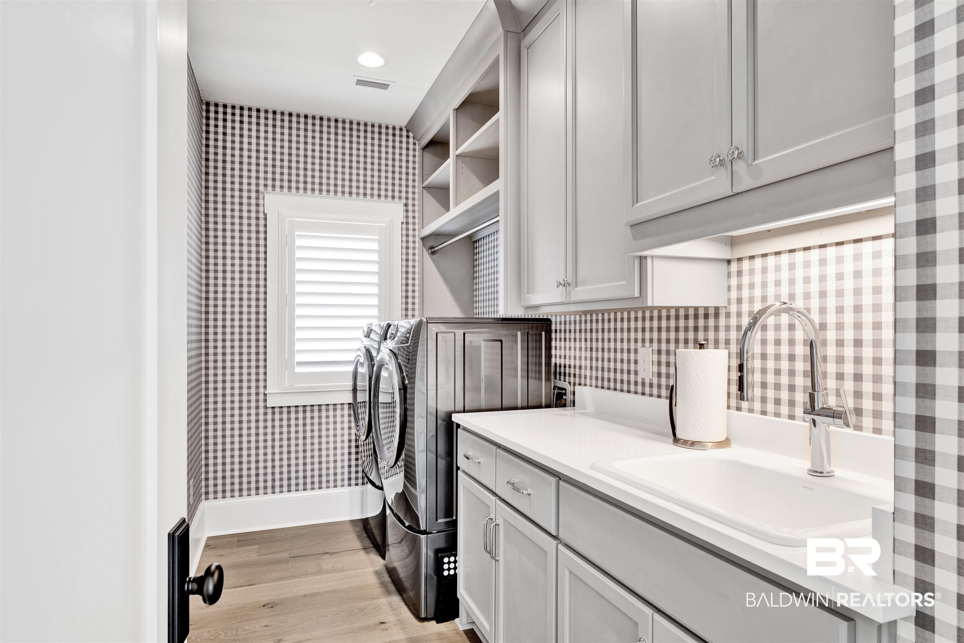 861 Inlet Circle Gulf Shores, AL 36542 - Photo 36 of 54 Laundry room with wallpapered walls, cabinet space, light wood finished floors, and independent washer and dryer