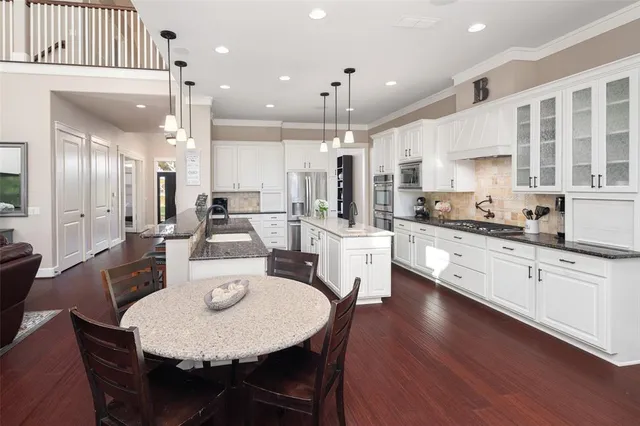a large kitchen with a table and chairs