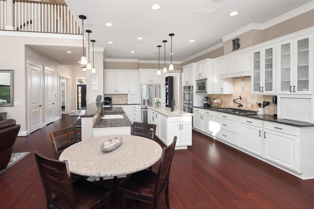 a large kitchen with a table and chairs