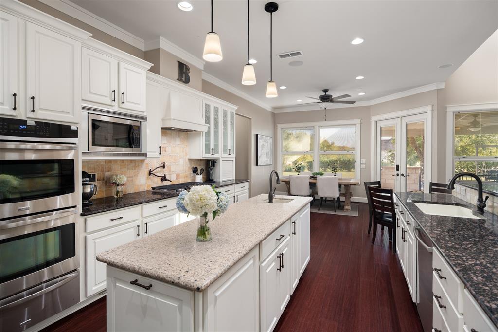 1814 Stacy Road Fairview, TX 75069 - Photo 11 of 36 a large kitchen with stainless steel appliances granite countertop a lot of counter space a sink and a wooden floors