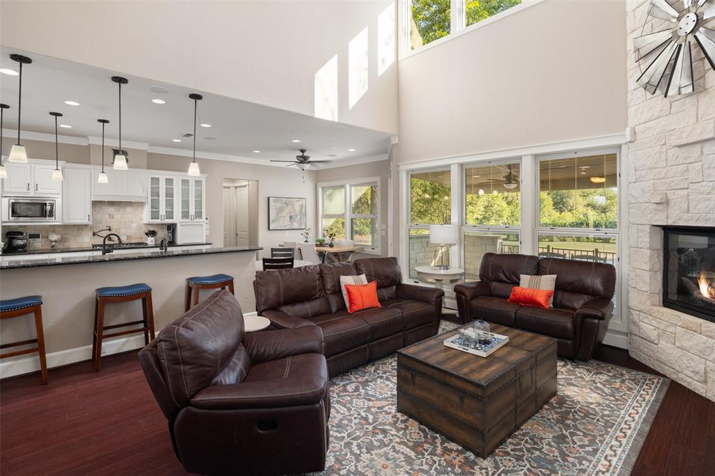 1814 Stacy Road Fairview, TX 75069 - Photo 15 of 36 a living room with furniture and a fireplace