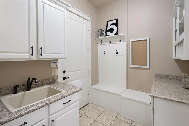 a bathroom with a sink and mirror with bathtub